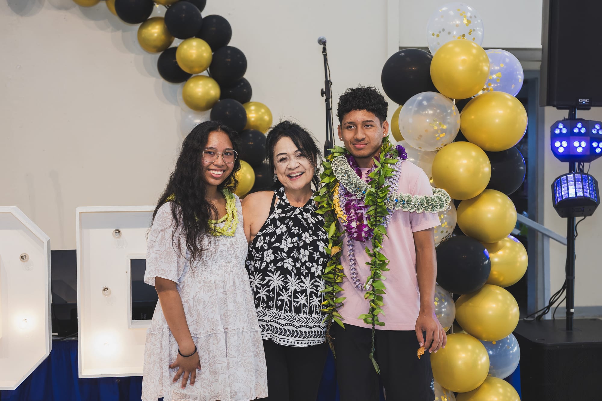 Graduate celebrating with family at an Oahu graduation party